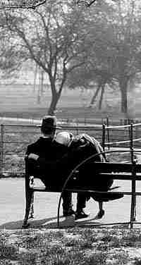 couple sitting quietly on bench in empty park
