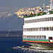 portion of photo of ferry with olympics in background